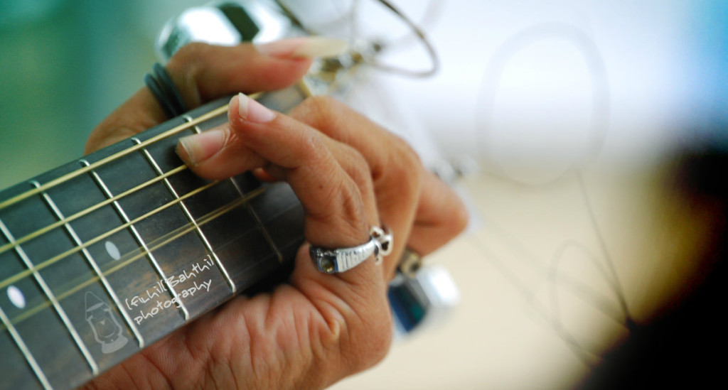 guitar strings and hand